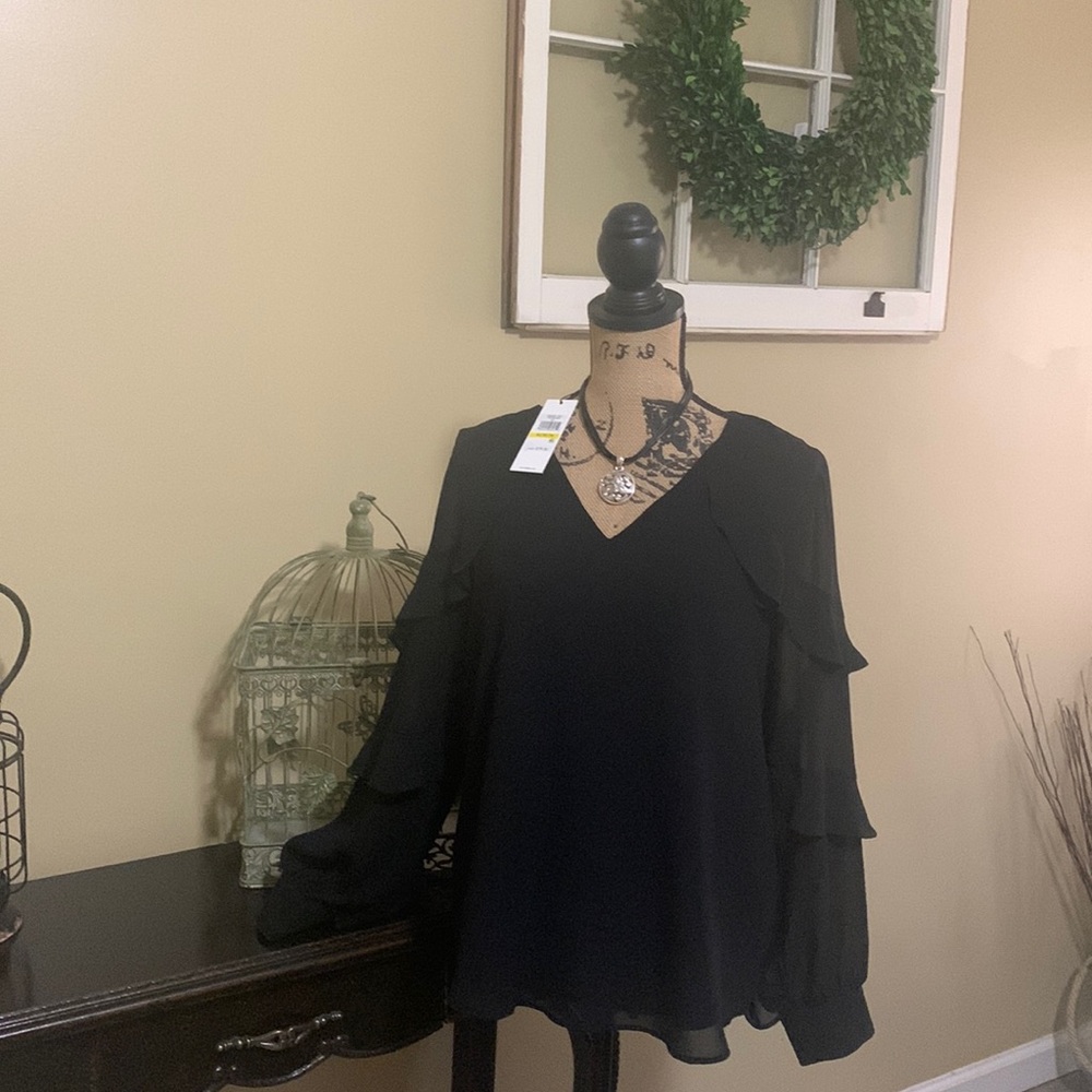 New with tags. Beautiful lined black Calvin Klein blouse.